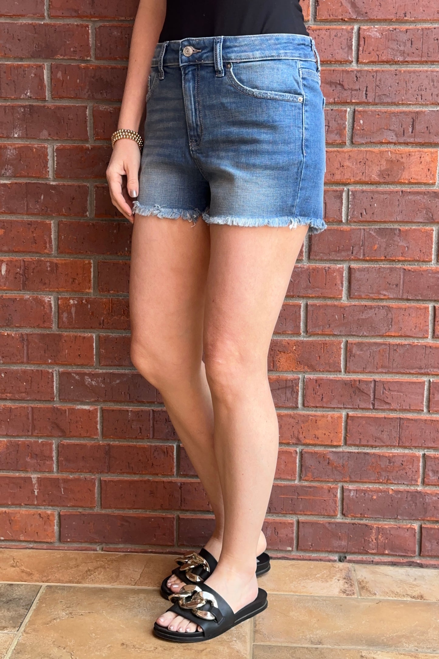 Mid-Rise Raw Fringe Hem Medium Wash Shorts